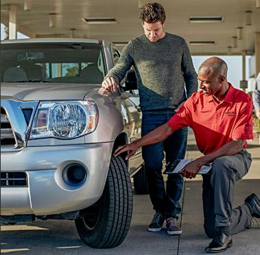 Service technician putting on a new Toyota tire.