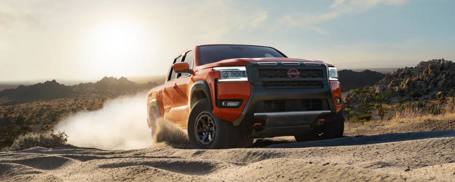 2026 Nissan Frontier PRO-4X driving on a rugged dirt trail