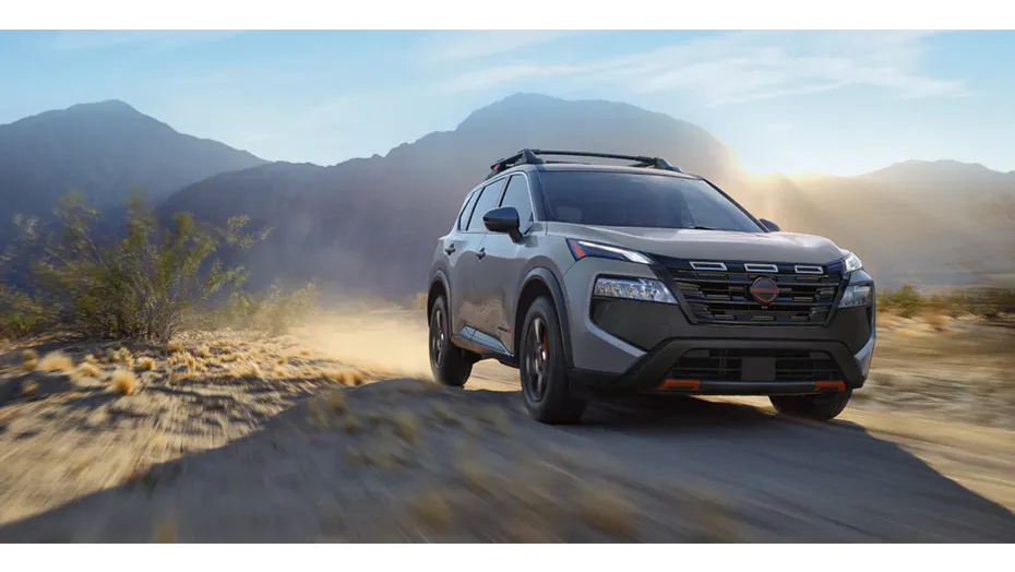 Nissan Rogue SUV driving on an outdoor trail