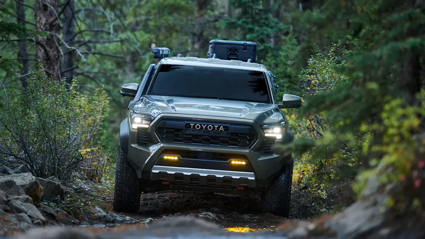2026 Toyota Tacoma driving through muddy trail