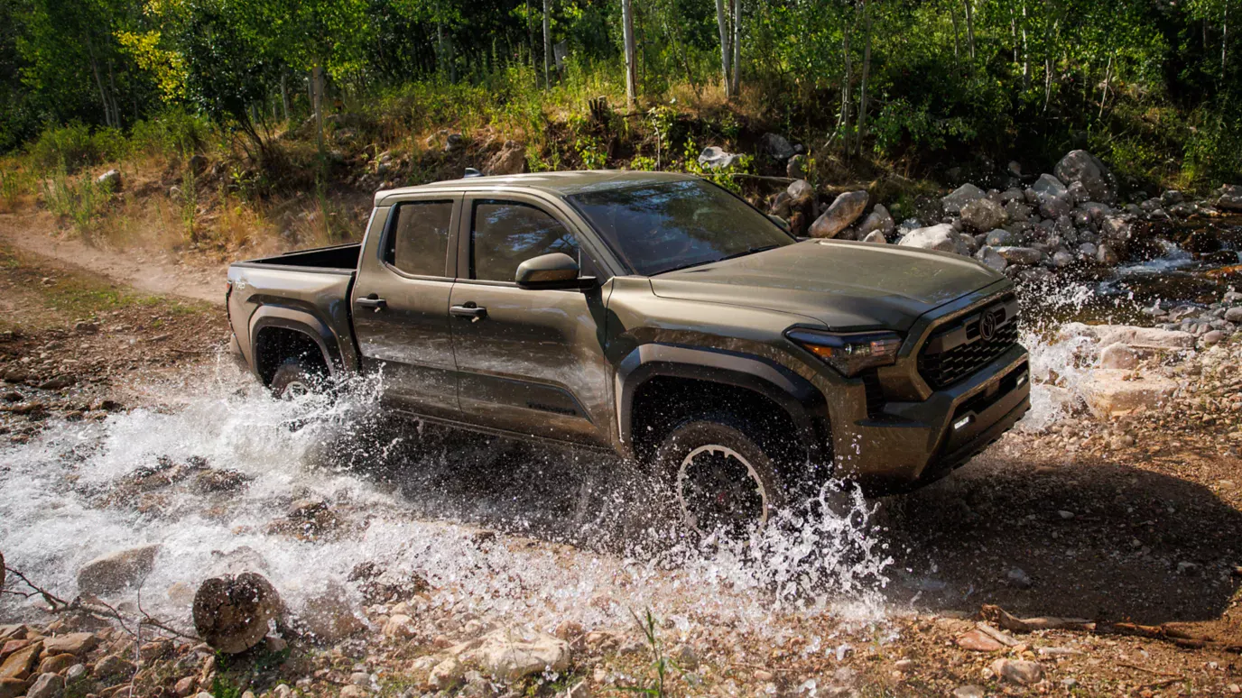 2026 Toyota Tacoma driving through a stream